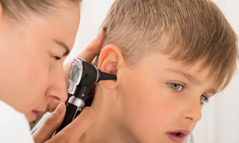 doctor checking kid's ear