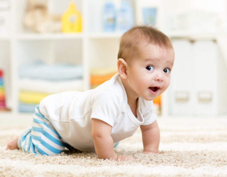 crawling funny baby boy indoors at home