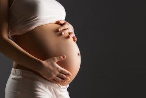 pregnant woman caressing stomach